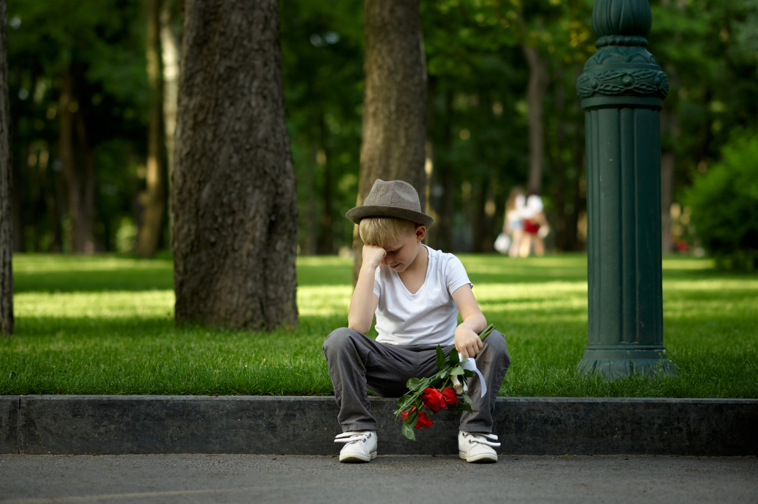 Sad boy with bouquet, girl did not come on a date
